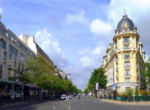 Wide boulevard in Paris with classic buildings and street activity