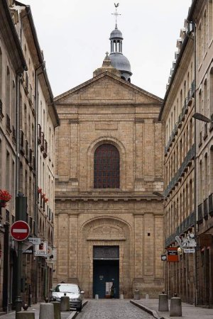 Facade of Saint-Sauveur Basilica in Rennes seen from east end of rue du Guesclin with belfry peak and inscription above portal