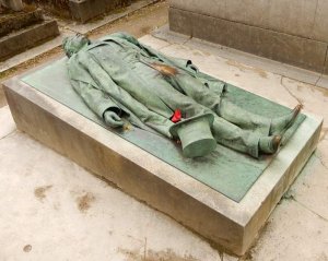 Tombstone with statue commemorating Victor Noir at Pere-Lachaise cemetery in Paris