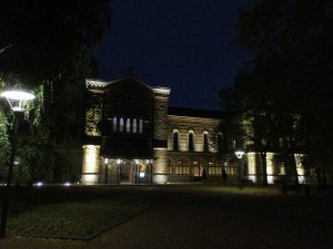 Fourvière Hôtel illuminated at night with city lights