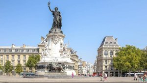 Monument at Place de la République in Paris with statues and flags