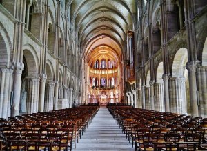 Interior nave view of Basilica of Saint-Remi in Reims with arches and columns