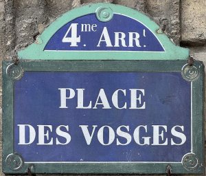 Street sign showing the name Vosges Square in Paris