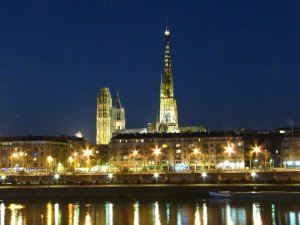 Rouen Cathedral illuminated at night along the right bank of the Seine River