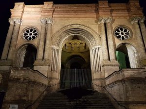 Illuminated arch inside Saint-Aubin church at night in Toulouse