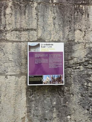 Stone exterior of St. Peter's Cathedral in Annecy under partly cloudy sky
