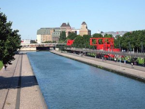 View of Canal de l'Ourcq with old Pantin mills and Zénith concert hall bubble in Parc de la Villette Paris