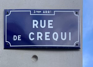 Rue de Créqui street name sign with blue background and white text in Lyon