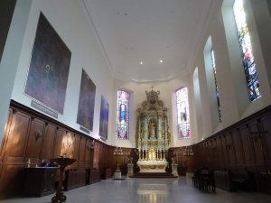 Interior view of Saint-Louis Church choir in Strasbourg featuring the altar by Théophile Klem and restored paintings by Martin Feuerstein