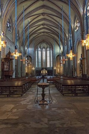 Interior view of Carcassonne Cathedral showing architectural details and stained glass windows