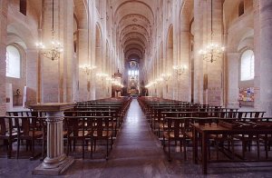 Nave interior of the Basilica of St Sernin with arched ceilings and rows of columns