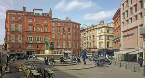 View of Place de la Trinité square in Toulouse with surrounding buildings and urban scenery
