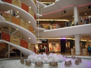 Fountain with a geyser reaching the top level inside Westfield La Part-Dieu shopping center