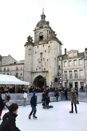Children enjoying a synthetic ice rink on Place Barentin in La Rochelle during winter festivities