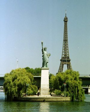 Statue of Liberty on Ile aux Cygnes with Eiffel Tower in the background in Paris