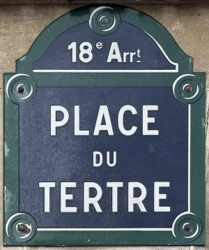 metal street sign plaque reading Place du Tertre mounted on a Paris building wall