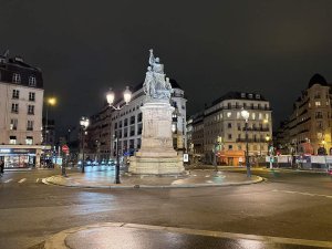 nighttime view of Place de Clichy square in Paris illuminated by street lights