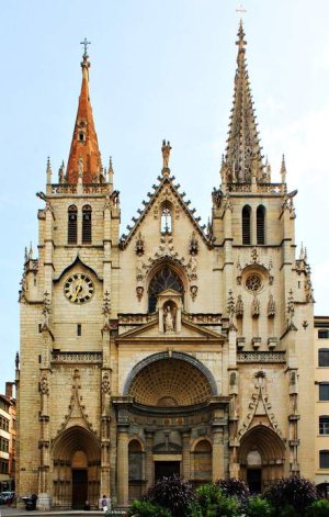 Ornate gothic facade of Saint-Nizier Church in Lyon under clear sky