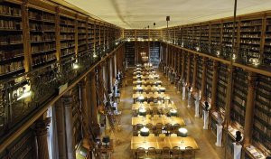 Interior reading room of the Bibliothèque Mazarine with desks and bookshelves