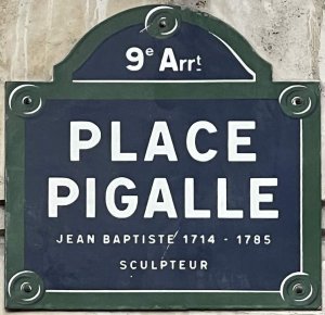 Blue and white street name sign for Place Pigalle in Paris