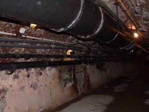 Interior corridor of Paris sewers with vaulted ceilings and brick walls