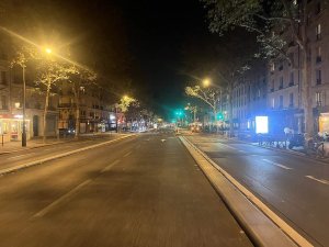 Nighttime view of Boulevard du Montparnasse in Paris with illuminated street and buildings