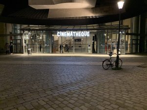 nighttime view of the Cinémathèque Française building illuminated in Paris