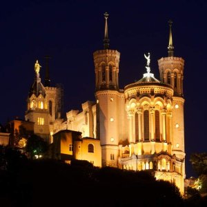 Basilica of Notre-Dame de Fourvière illuminated at night overlooking Lyon