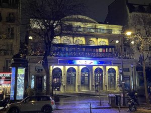 nighttime view of Théâtre du Gymnase Marie Bell illuminated in Paris