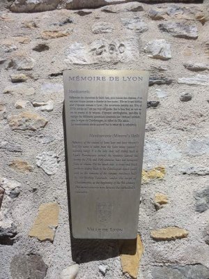 Explanatory plaque about the Manécanterie in Lyon mounted on a wall