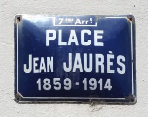 Close-up view of the Place Jean-Jaurès name plaque in Lyon's 7th arrondissement