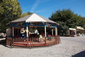 colorful carousel with amusement ride horses in Parc de la Villette Paris