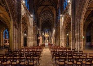Interior view of Saint-Merri Church showcasing gothic arches, stained glass windows, and ornate altar
