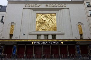 Illuminated exterior of the Folies Bergère theater in Paris at night
