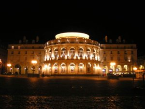 Rennes Opera house illuminated at night with surrounding urban lights
