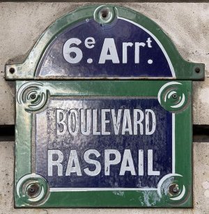 Street sign for Boulevard Raspail in Paris showing the street name plaque