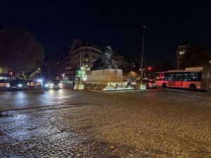nighttime view of Place Denfert-Rochereau in Paris with illuminated streets and buildings