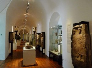 Central gallery interior of Strasbourg Archaeological Museum with display cases and artifacts