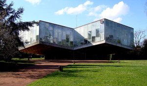 Elevated equatorial greenhouse structure with extensive glass panels and metal framework in Lille botanical garden