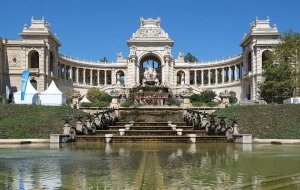 The marble fountain and grand sculptures at Palais Longchamp in an urban park setting