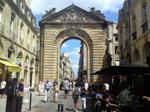 Ornate stone archway entrance of Porte Dijeaux in Bordeaux