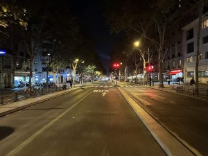 Nighttime view of Boulevard du Montparnasse in Paris with streetlights and buildings