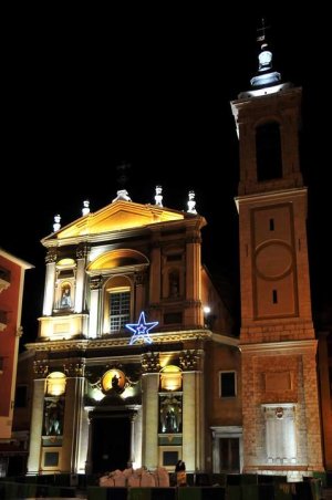 Nighttime view of Nice Cathedral St. Reparate illuminated against the evening sky