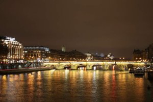 Pont Neuf illuminated at night spanning the Seine River in Paris